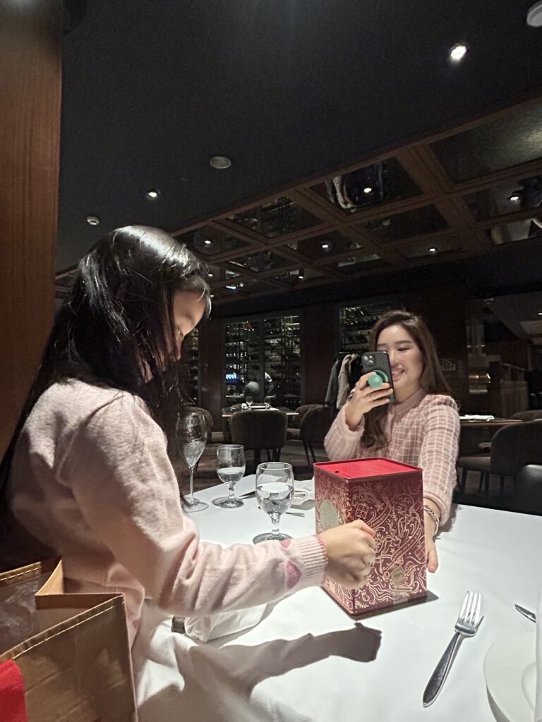 A joyful moment shared by a Seoul insider, her 7-year-old daughter, and an American friend, enjoying a sophisticated family dinner in Gangnam