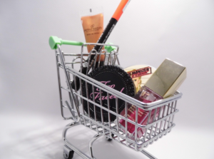 An cosmetic shopping cart packed with various skincare and makeup products.