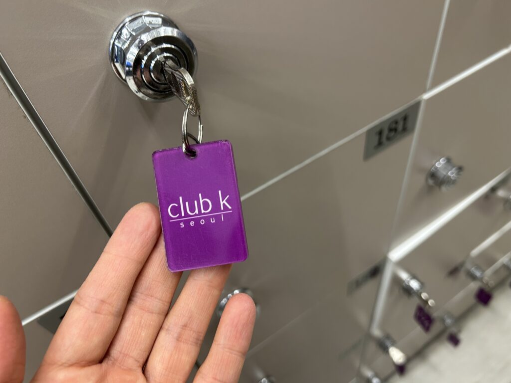 A close-up of the shoe locker key at Club K Seoul. In this system, you exchange this shoe locker key at the front desk for a separate locker room key and spa uniform.