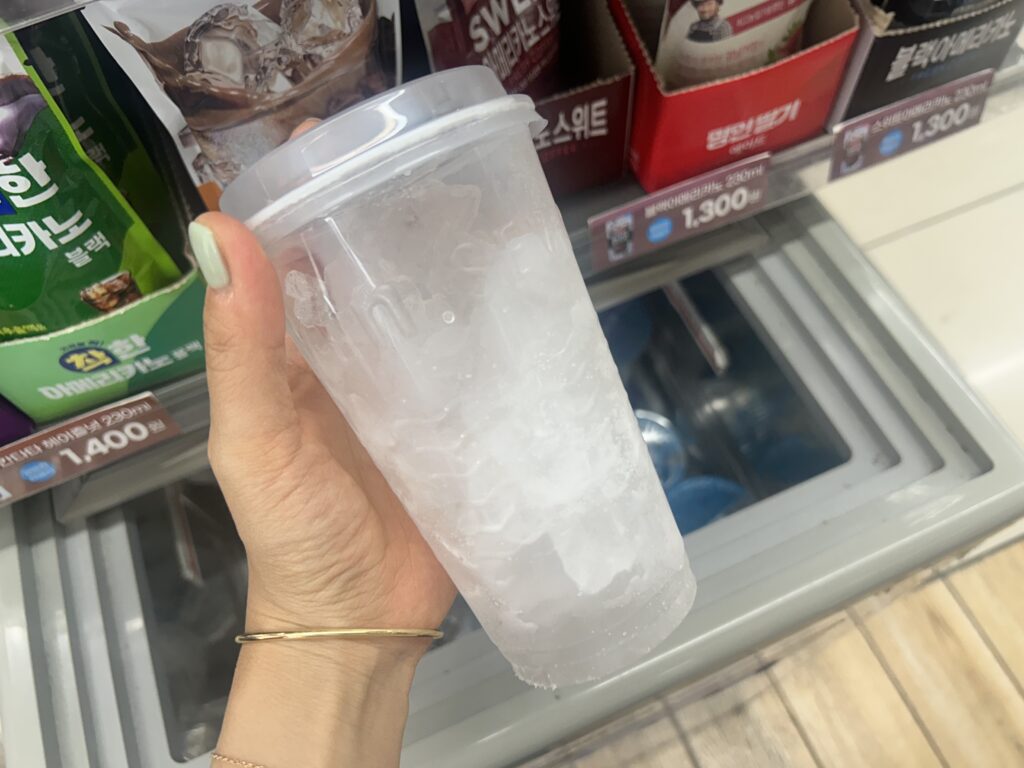 Ingredients to make the viral Ttungba Latte: a packaged plastic ice cupfrom a Korean convenience store.