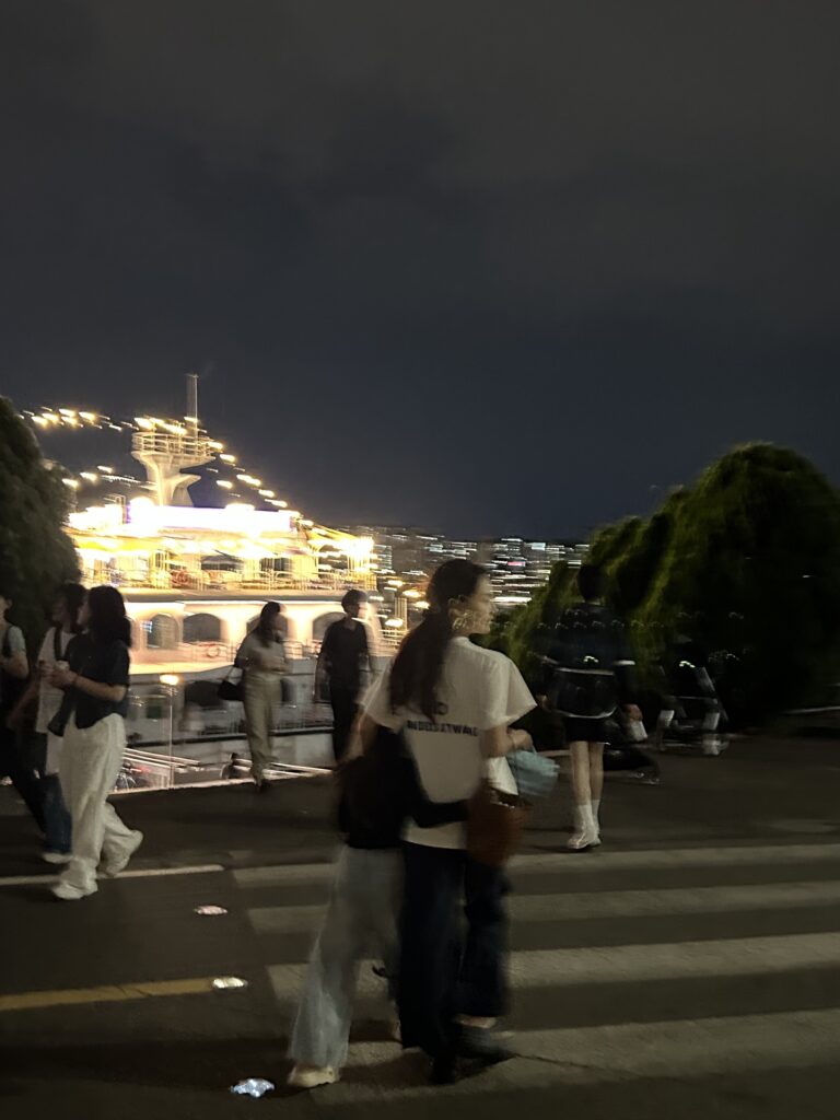 Seoul Travel Guide: A mother walking along the riverside paths of Jamwon Han River Park with her kids during a breezy early summer evening in Seoul.