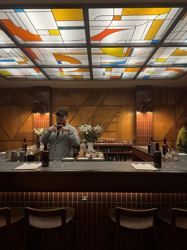 The main bartender at Bar Kiez in Gangnam, Seoul, mixing a trendy drink in a hip and welcoming atmosphere.