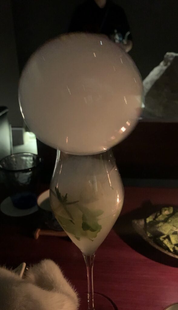 A signature tea cocktail at Bar Tea Scent in Seoul, decorated with beautiful toppings reminiscent of soft clouds.