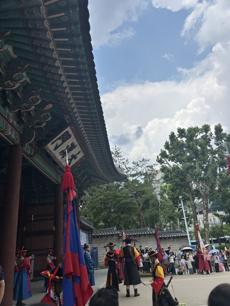 Royal guards dressed in colorful traditional Joseon Dynasty costumes performing the Royal Guard Changing Ceremony in front of Daehanmun Gate at Deoksugung Palace.