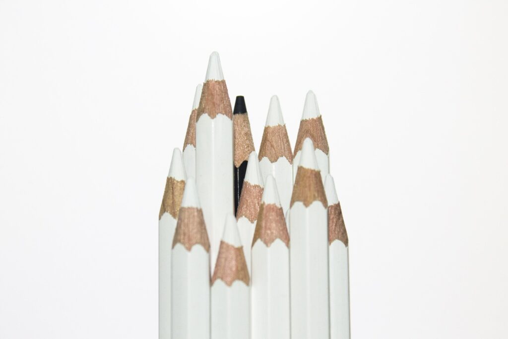 One black colored pencil standing out among monochromatic pencils, representing individuality and distinction as BTS Grammy Boycott