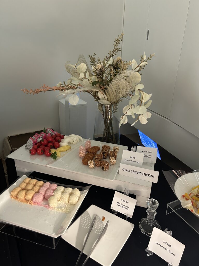 Close-up of catered party snacks, cocktails, and wine glasses set up for guests at a gallery reception during Frieze Seoul 2026 Samcheong Night.